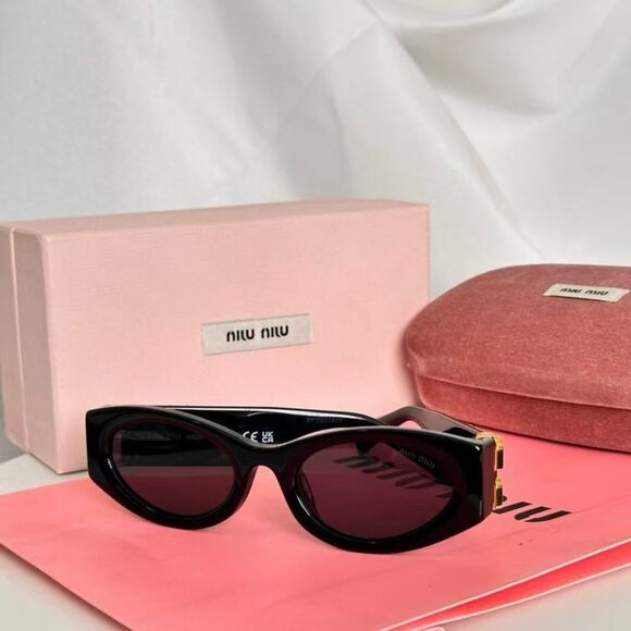 Miu Miu black sunglasses featuring elegant gold accents